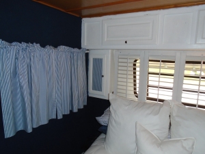 Blue stripe blackout curtains and fabric on cabinet. "Shutter Heaboard" for light filtering and privacy 